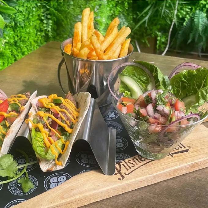 mexican carne asada tacos dish laid out with salad and chips