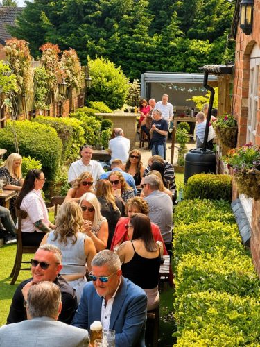 happy guests in the 4 penny beer garden enjoying the sunshine